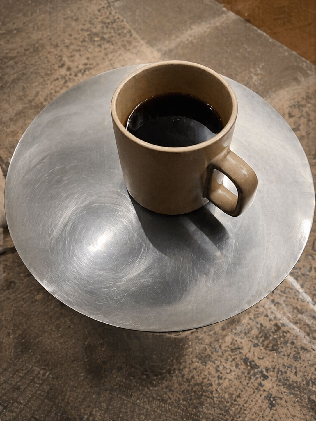 Black coffee on a stainless steel table